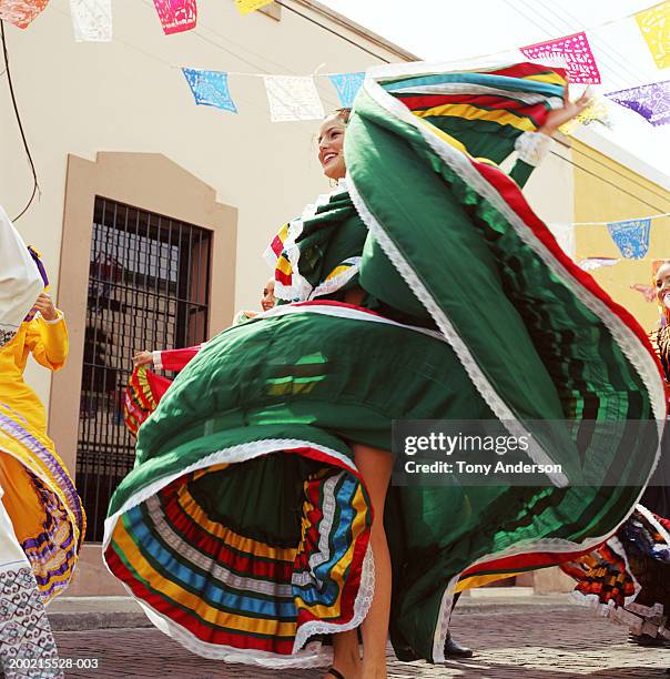 young woman wearing traditional dress, dancing at fiesta - cultura latino americana foto e immagini stock