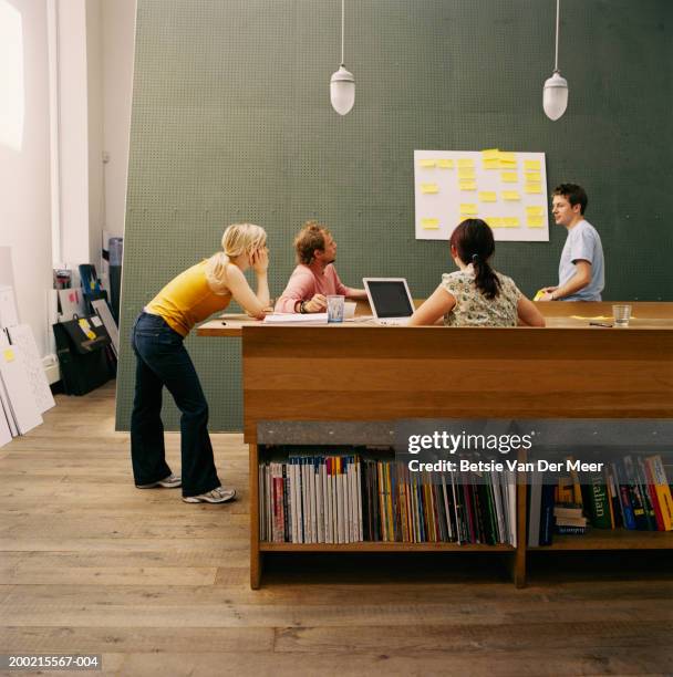 four male and female colleagues having meeting in studio - design studio stock pictures, royalty-free photos & images