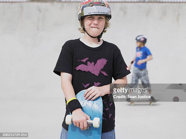 two boys (10-12) with skateboards on course, portrait - skating helmet stock pictures, royalty-free photos & images