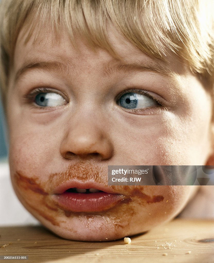 Boy (2-4) with food around mouth, close-up