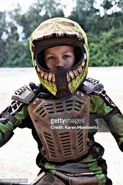 boy (11-13) wearing protective gear, sitting on dirt bike, portrait - motocross stock photos et images de collection