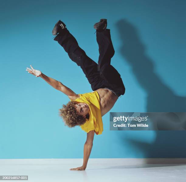 young man upside down, on one hand, portrait - street dance stock pictures, royalty-free photos & images