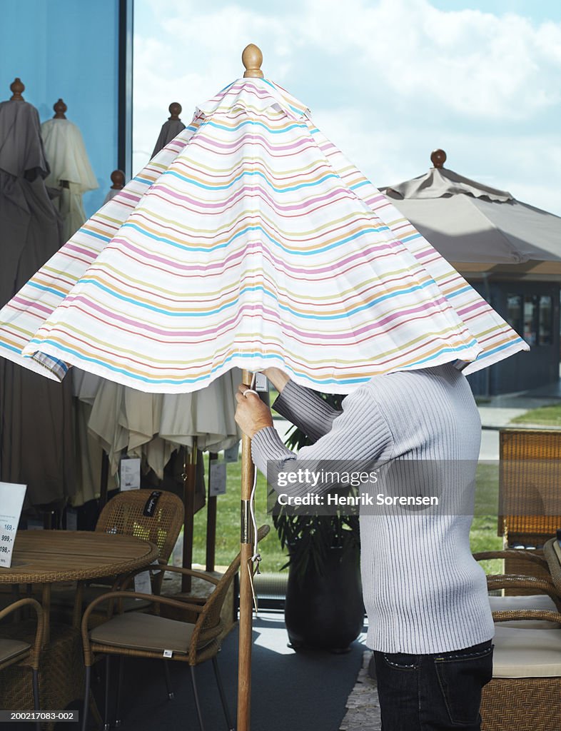 Man under parasol in garden centre