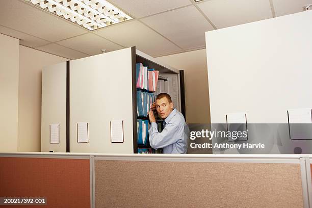 Man Searching Through Office Files Looking Over Shoulder High-Res Stock ...