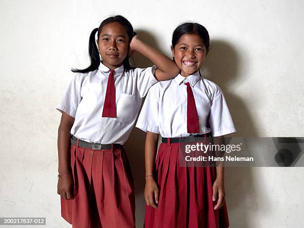two schoolgirls (9-13) smiling, portrait - school tie stock-fotos und bilder