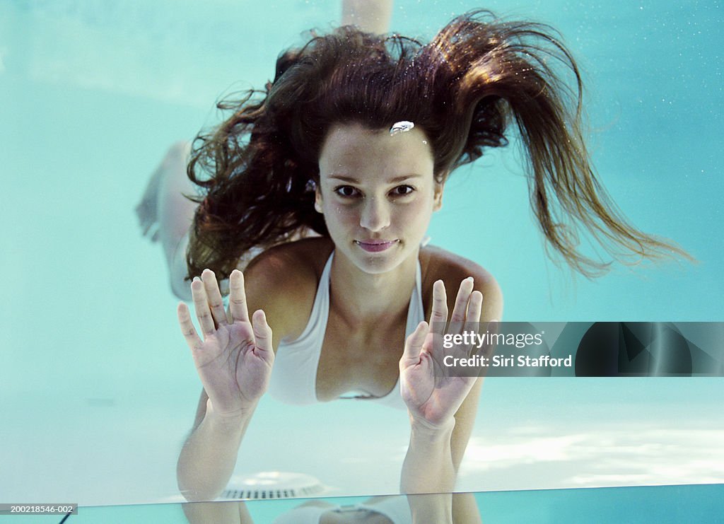 Young woman swimming  underwater