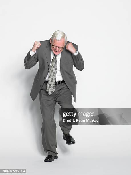 mature businessman stamping foot, clenching fists (blurred motion) - stamp stockfoto's en -beelden