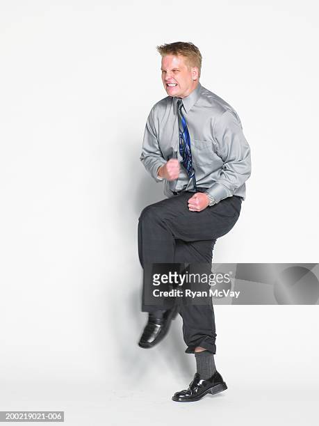 young businessman stamping foot, clenching fists (blurred motion) - stoneplus15 ストックフォトと画像