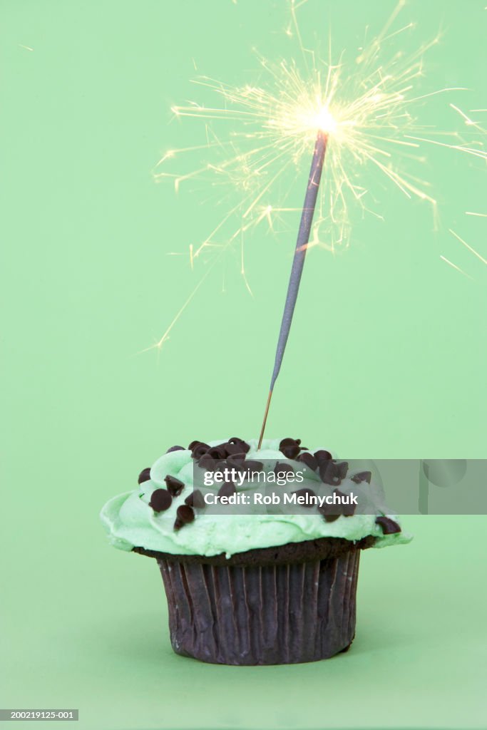 Lit sparkler atop cupcake