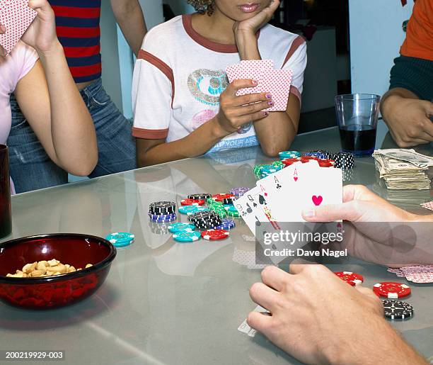 Friends Playing Poker In Apartment Man Holding Cards Closeup, Foto stock