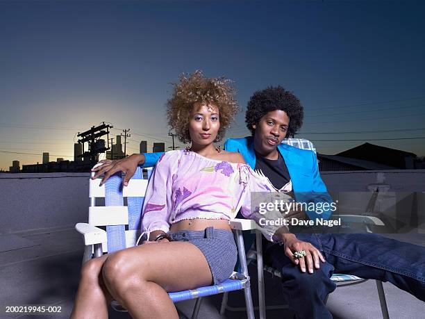 young couple in chairs on rooftop, portrait - big hair stock pictures, royalty-free photos & images