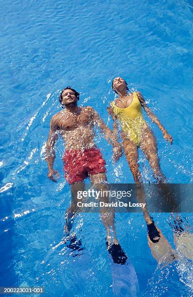 couple swimming backstroke, elevated view - swimming pool and hand stock-fotos und bilder