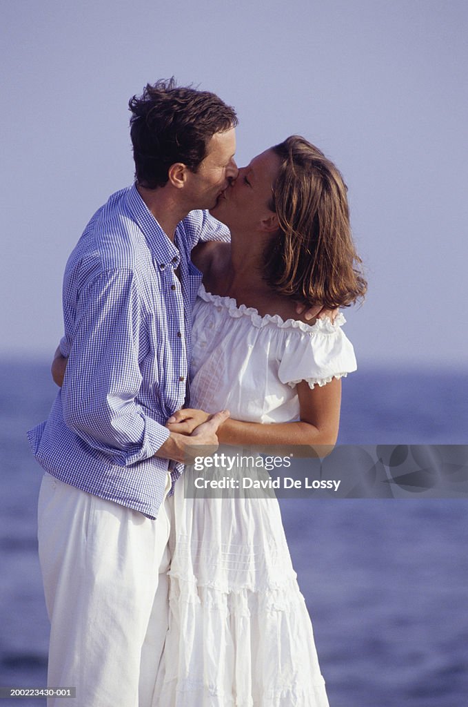 Couple kissing on beach