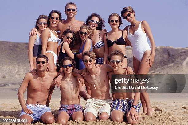 Group Of People With Two Young Girls On Beach Portrait High-Res