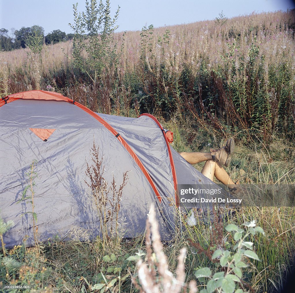 Man lying in tent, low section