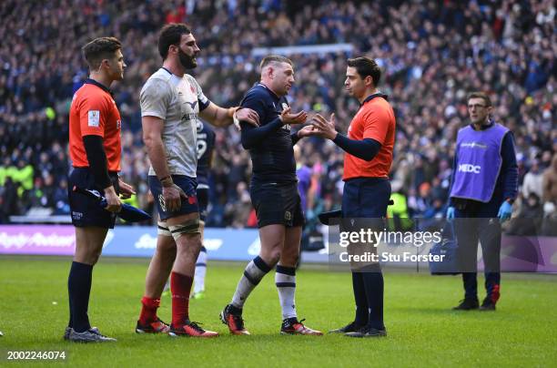 Assistant Referee, Nika Amashukeli talks to Finn Russell of Scotland as they await the decision of the final minute TMO after the Guinness Six...