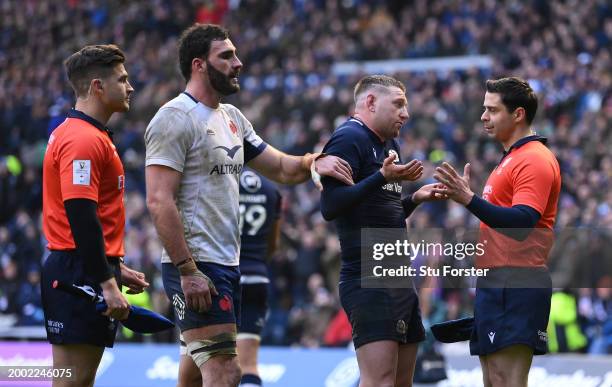 Assistant Referee, Nika Amashukeli talks to Finn Russell of Scotland as they await the decision of the final minute TMO after the Guinness Six...