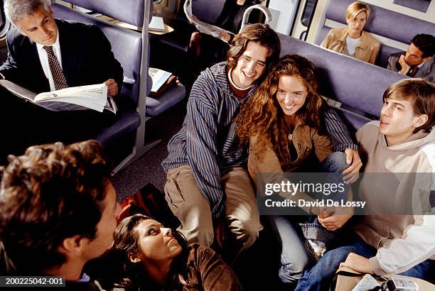 medium group of people talking on train - de lossy girl stock pictures, royalty-free photos & images