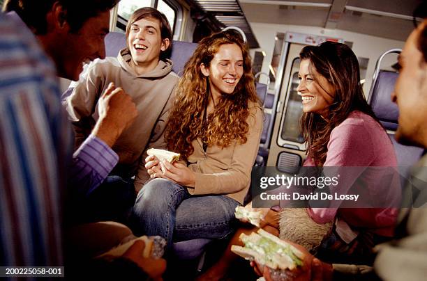 friends eating sandwiches on train - girls laughing eating sandwich stock-fotos und bilder