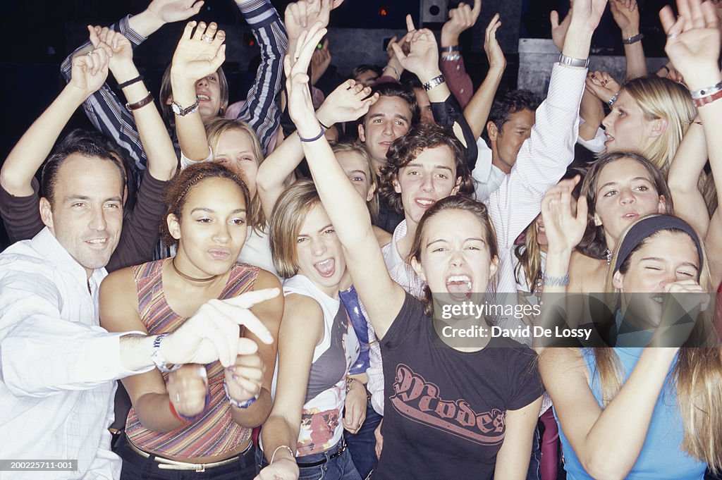 Group of young people dancing at concert