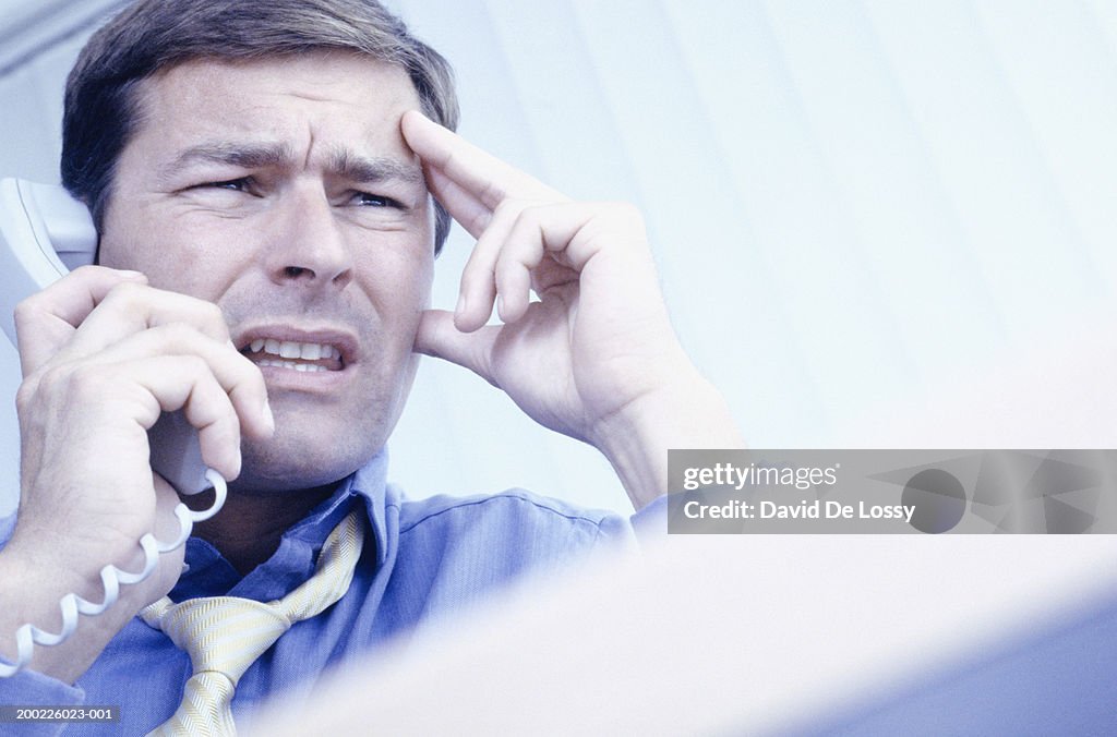 Businessman talking on phone in office