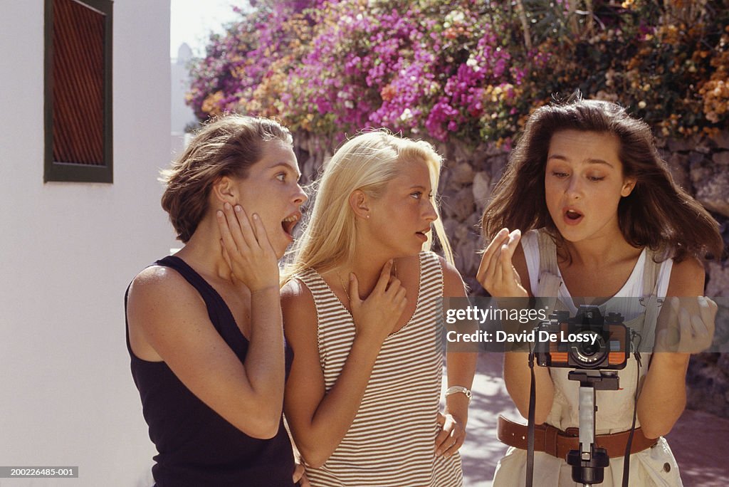 Three girls in garden with camera on tripod