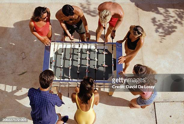 medium group of people playing foosball, overhead view - medium group of people foto e immagini stock