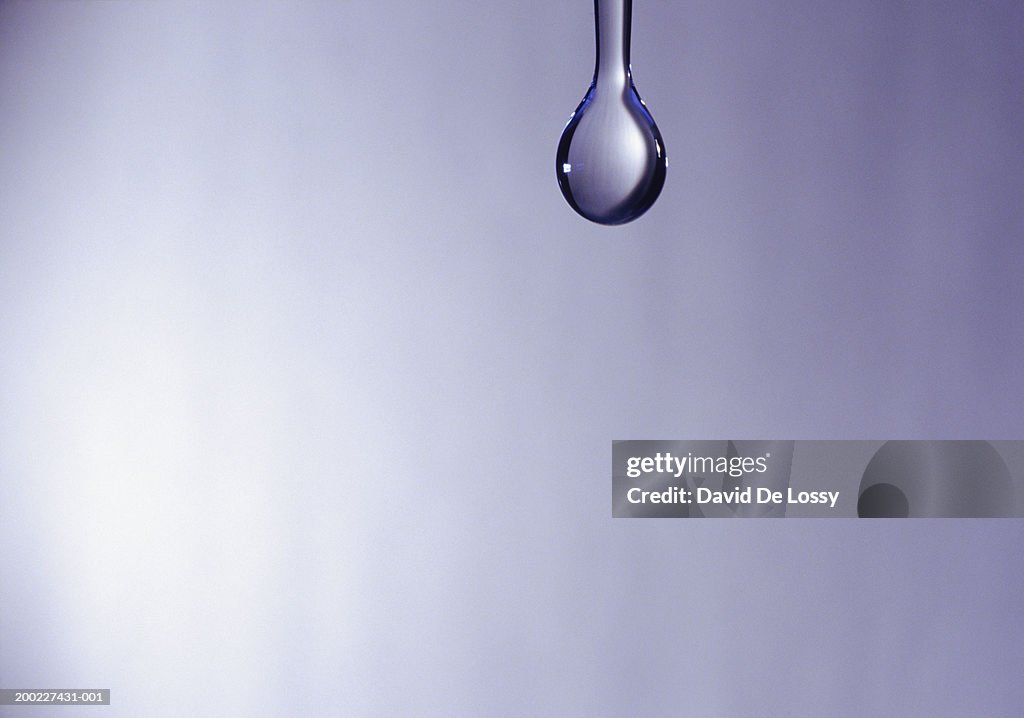 Water droplet hanging down, close-up