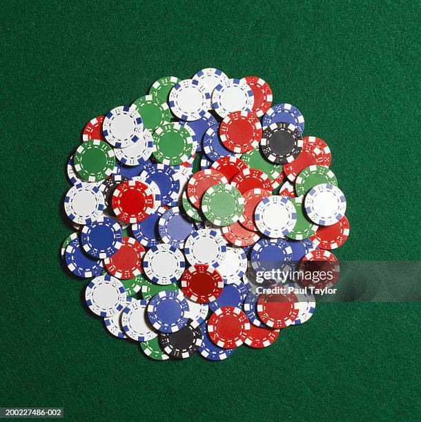 poker chips in pile on casino table - gambling chip stock pictures, royalty-free photos & images