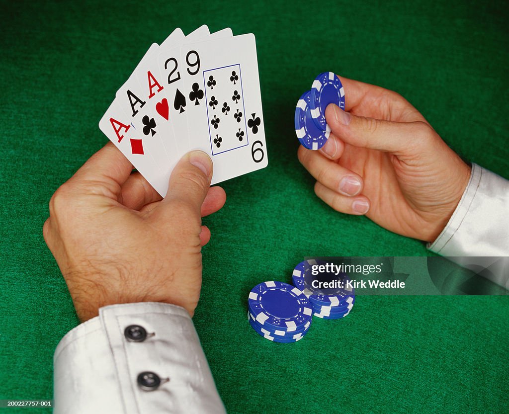 Man catching wad of crumpled paper, close-up of hand