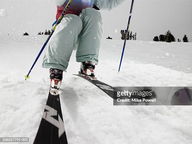 female skier, skiing on slope (low section) - スキーパンツ ストックフォトと画像