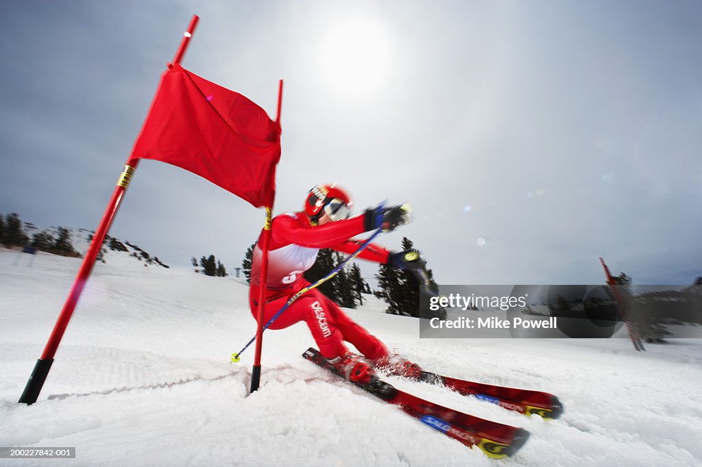 Female skier in giant slalom ski race (blurred motion)