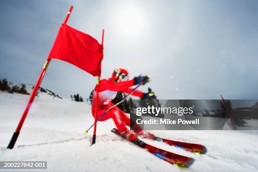 Female skier in giant slalom ski race (blurred motion) Female skier in giant slalom ski race (blurred motion)