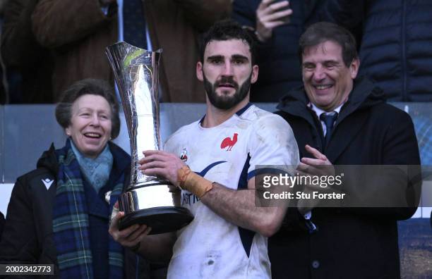 Charles Ollivon of France receives the Auld Alliance Trophy as HRH Princess Anne looks on after the Guinness Six Nations 2024 match between Scotland...