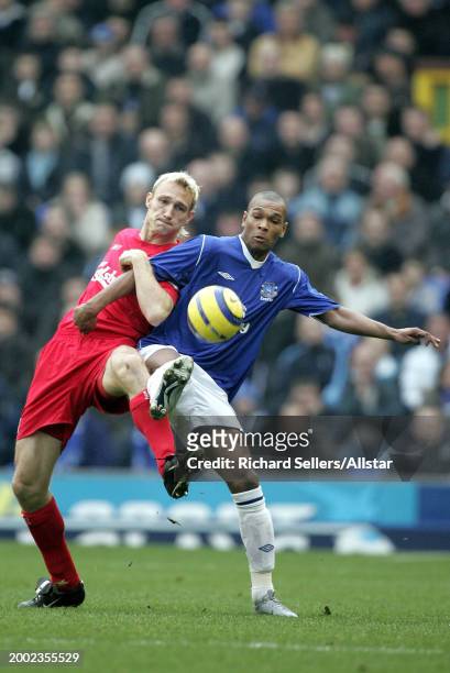 Marcus Bent of Everton and Sami Hyypia of Liverpool challenge during the Premier League match between Everton and Liverpool at Goodison Park on...