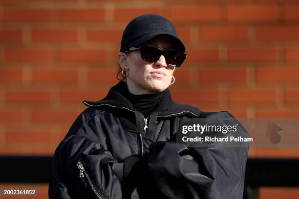 Jess Glynne looks on from the stands prior to the Adobe Women's FA Cup Fifth Round match between Arsenal and Manchester City at Meadow Park on...