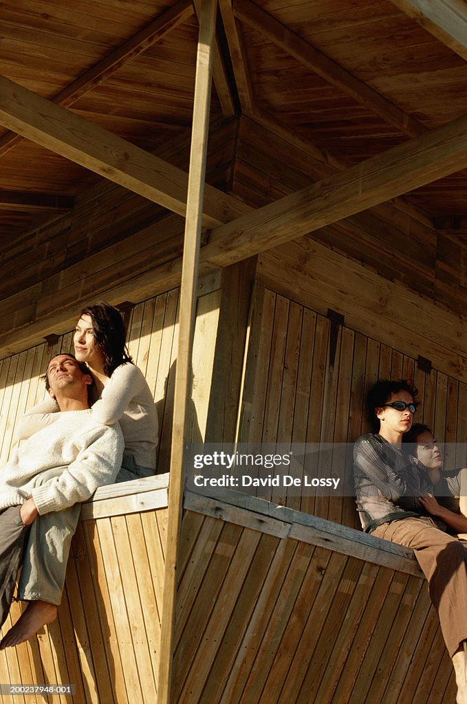 Young couples sitting, low angle view