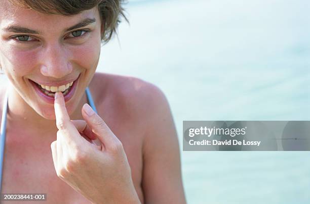 young woman at sea - finger in mouth fotografías e imágenes de stock