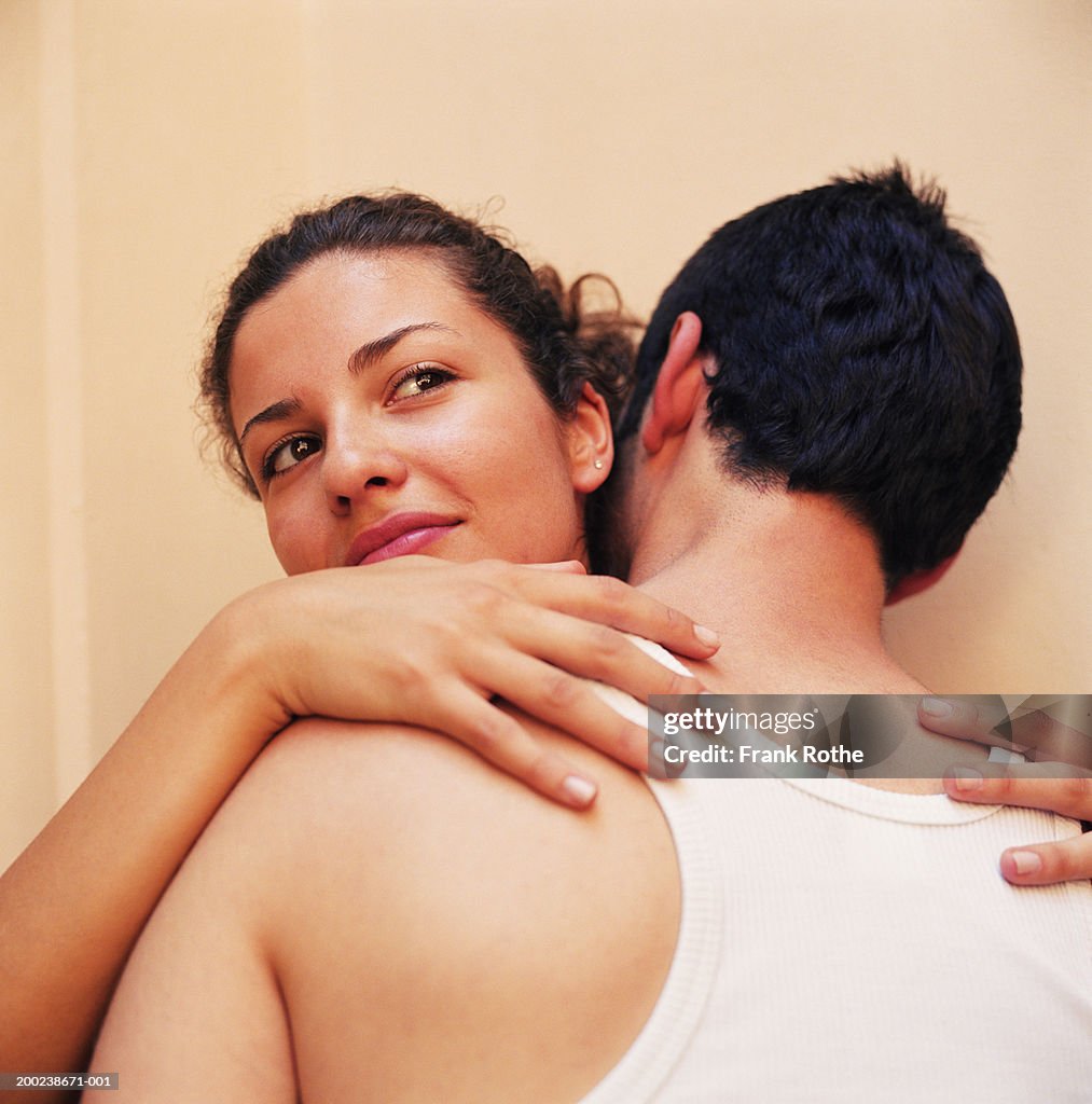 Young couple embracing, close-up