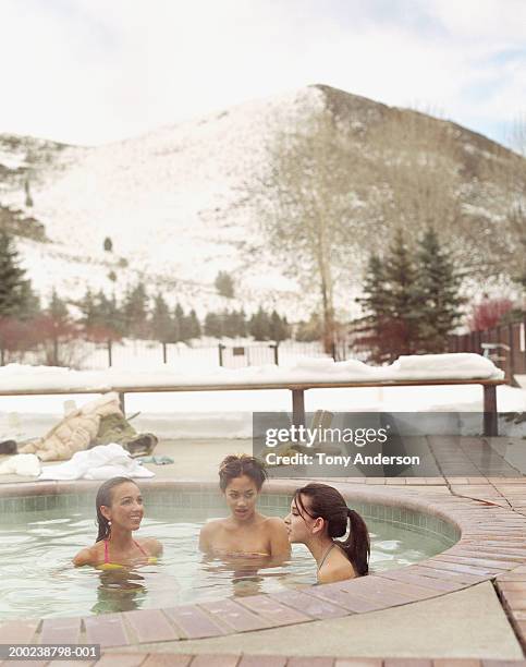 woman and teenage girls (14-17) soaking in outdoor hot tub - girls in hot tub fotografías e imágenes de stock