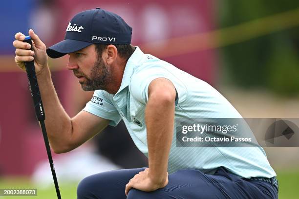 Scott Jamieson of Scotland lines up a putt on the 15th green during day four of the Commercial Bank Qatar Masters at Doha Golf Club on February 11,...