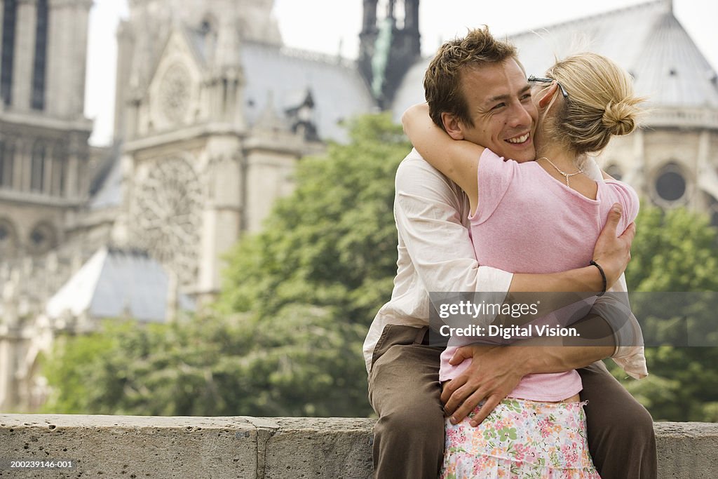 France, Paris, couple embracing, man smiling