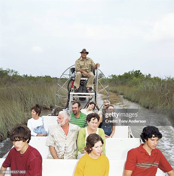 tourists riding in air boat through swamp - everglades nationalpark stock-fotos und bilder