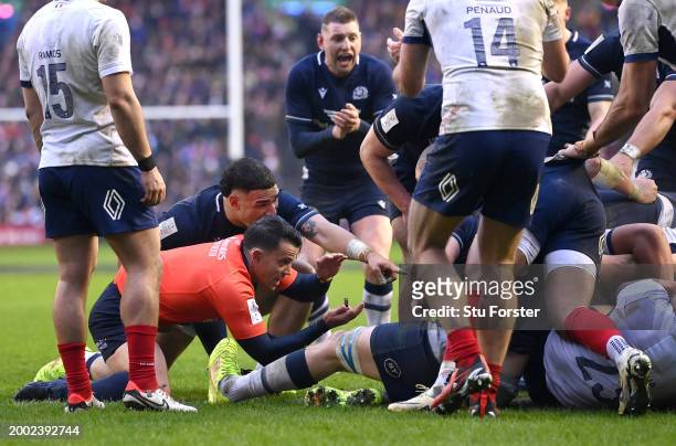 Scotland centre Sione Tuipulotu and Finn Russell react as Referee, Nic Berry signals that the ball is held up as Sam Skinner of Scotland attempts to...