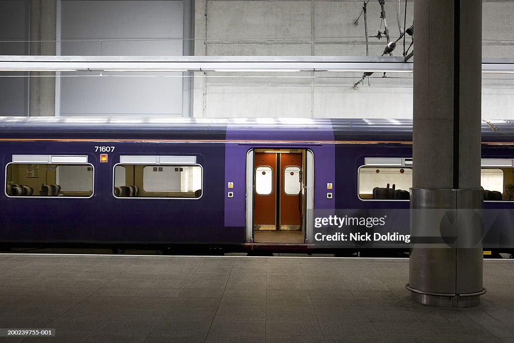 Train with doors open, parked at station