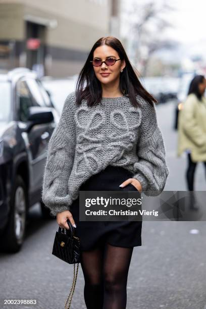 Guest wears grey Loewe knit, black skirt, Chanel bag, tights outside Badgley Mischka on February 10, 2024 in New York City.