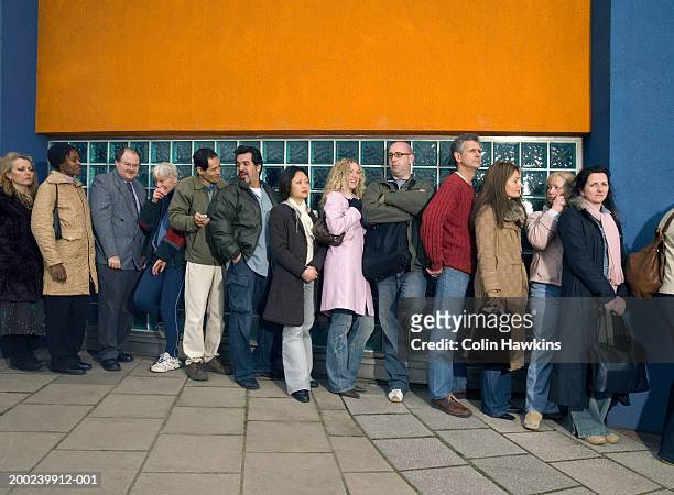 group of people standing in line outdoors - lining up bildbanksfoton och bilder