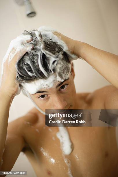 teenage boy (13-15) washing hair in shower, close-up - boy taking a shower stock-fotos und bilder