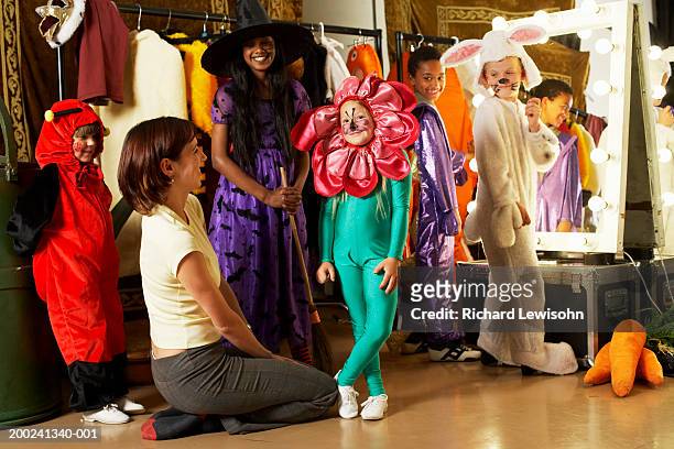 children (5-9) and teacher backstage, portrait of girl in flower costume - stage costume stock pictures, royalty-free photos & images