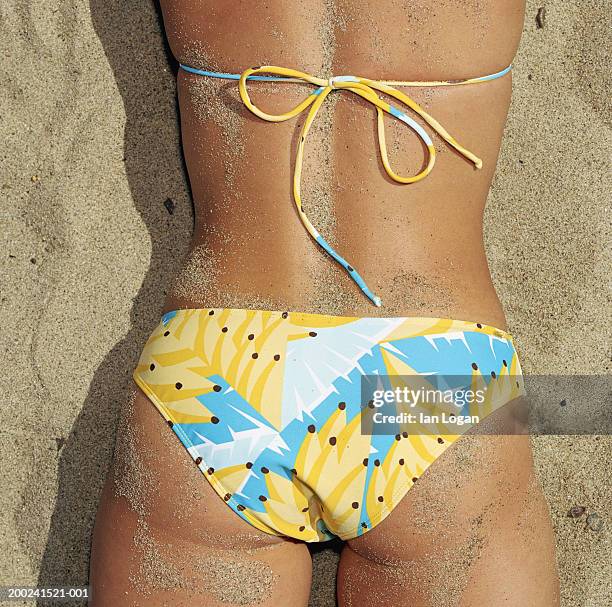 young woman lying on beach (mid section) - beach bum imagens e fotografias de stock